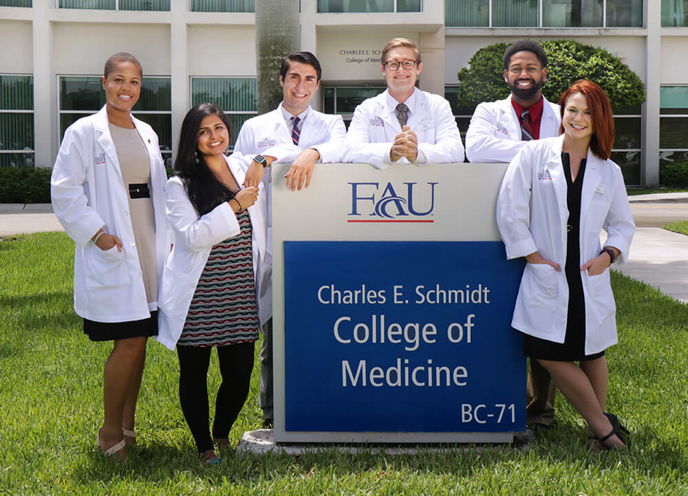 Medical and PhD students in front of the Charles E. Schmidt Building at FAU Boca Raton campus.